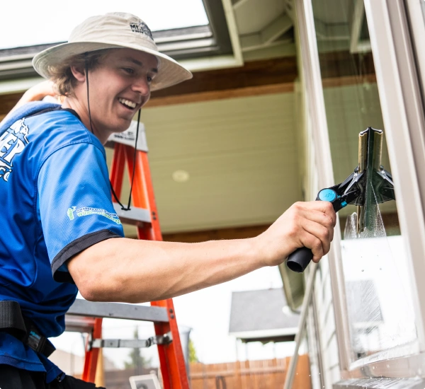 a man wiping a window clean