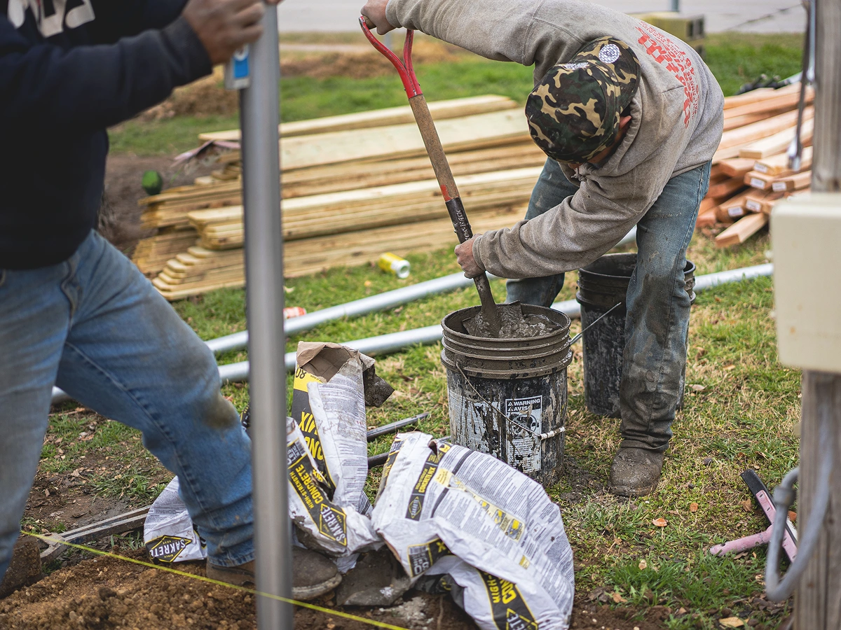 Two men working outside.