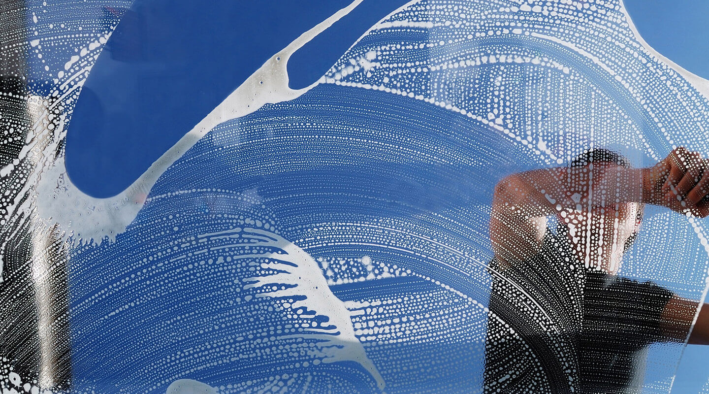 Janitorial Company Cleaning a Window