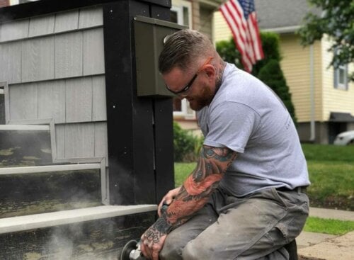 image of Ryaan Tuttle working on front steps