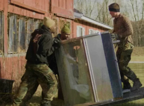 image of junk removal professionals hauling junk after using Jobber's junk removal software