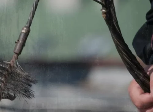 image of service provider holding a chimney sweep brush after using Jobber's chimney sweep software