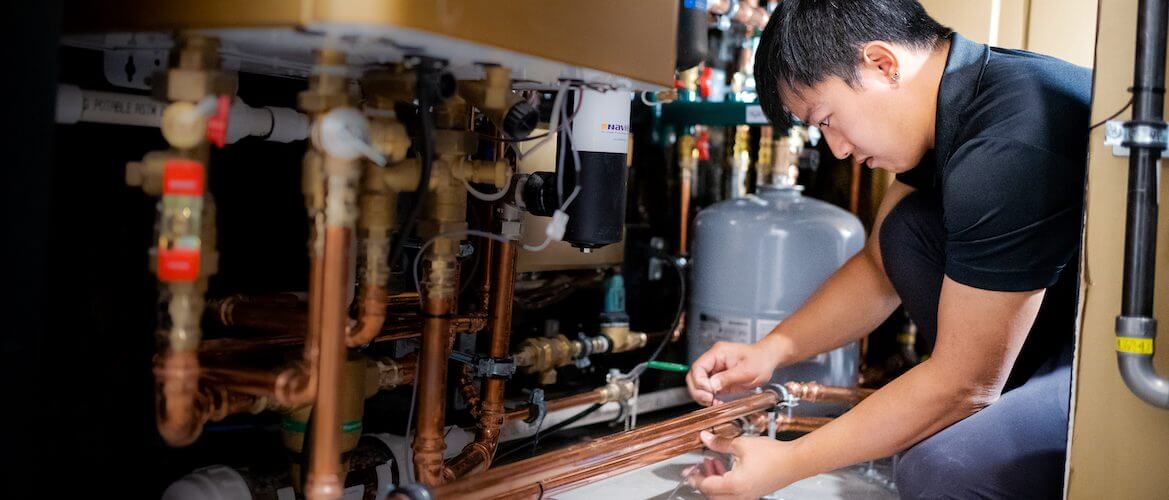 image of plumber sealing pipes