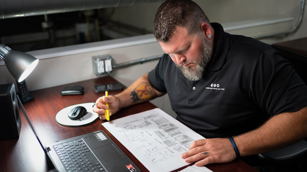 man working on paperwork in an office