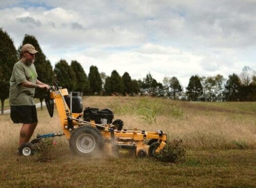 image of a lawn care contractor mowing a large field