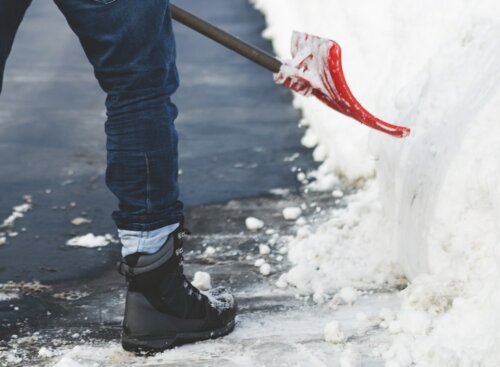 person shoveling driveway