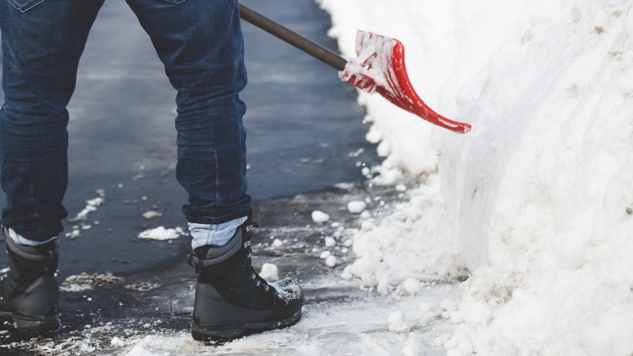 person shoveling driveway