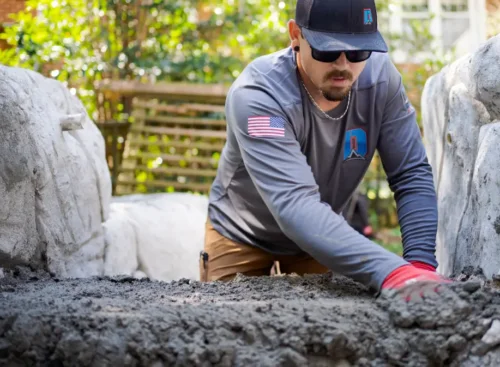 image of contractor spreading concrete after using Jobber's concrete contractor software