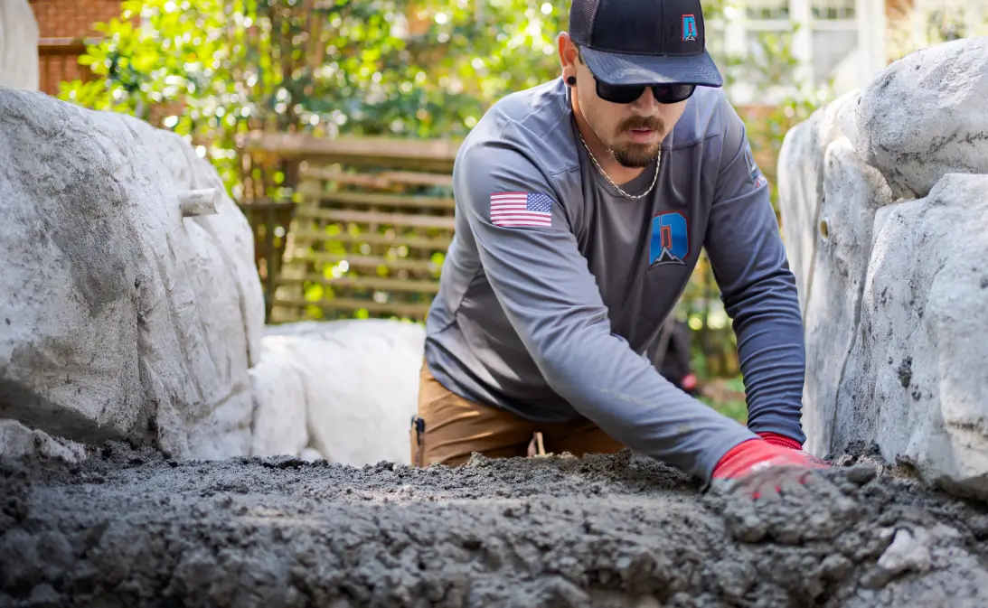 image of contractor spreading concrete after using Jobber's concrete contractor software