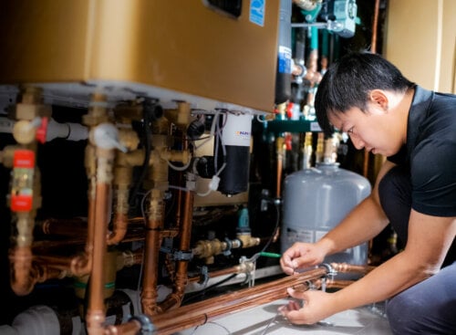 image of plumber repairing pipe