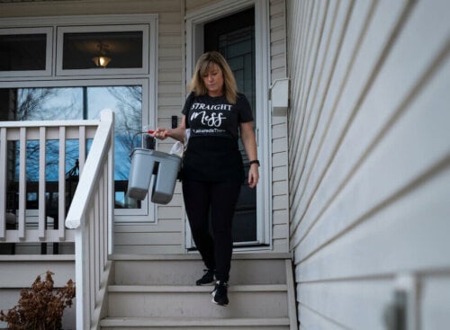 House cleaner walking down a home's front steps