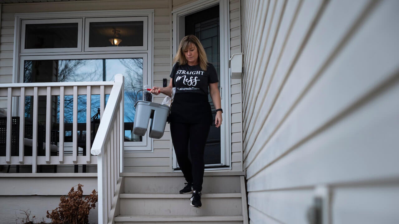 House cleaner walking down a home's front steps