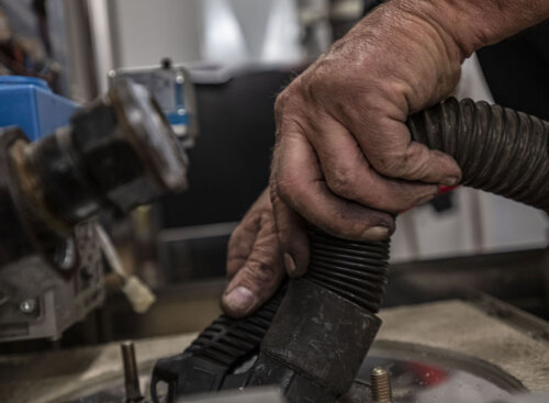 man's hands holding plumbing tools