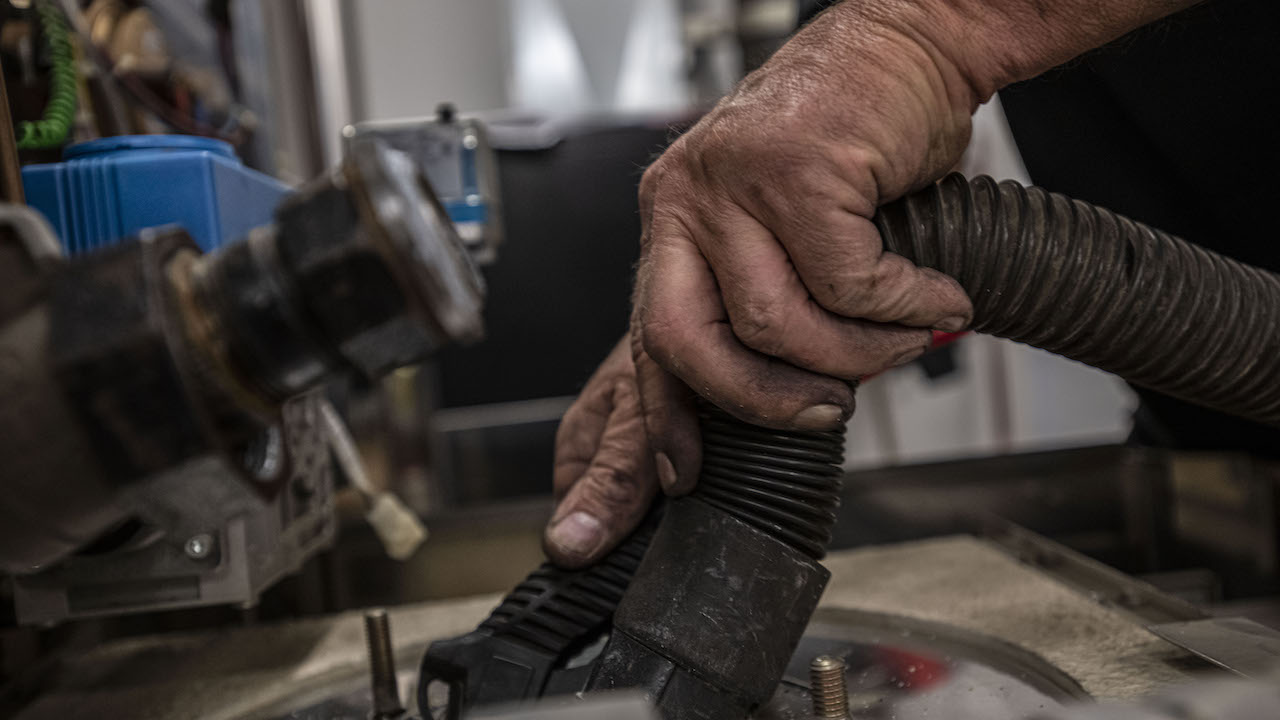 man's hands holding plumbing tools