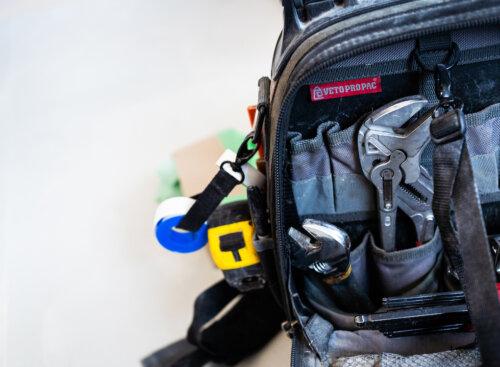 work bag full of plumbing tools