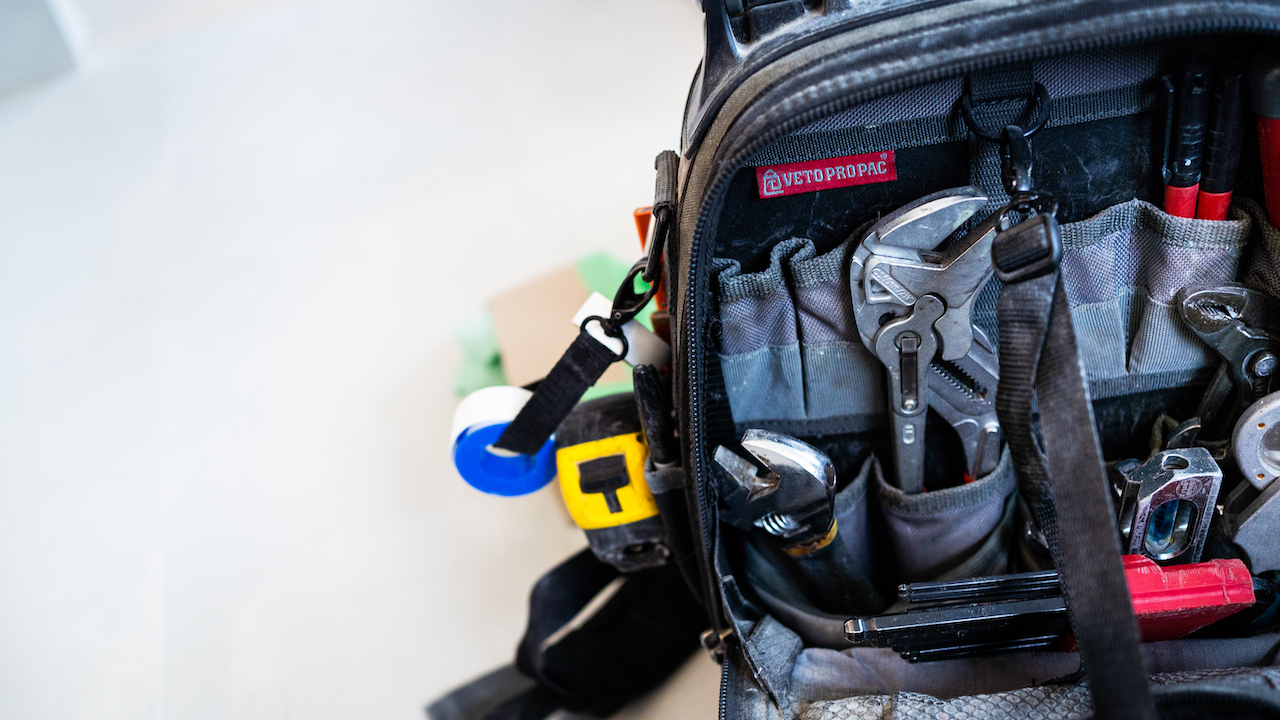 work bag full of plumbing tools