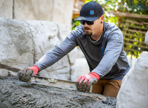 landscaper salary guide - landscaper leveling concrete