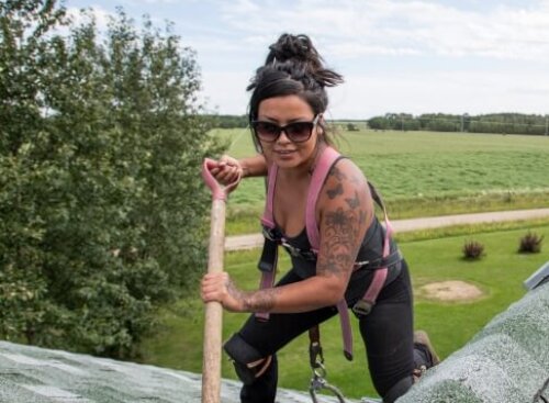 Homes Roofing: professional roofer on house