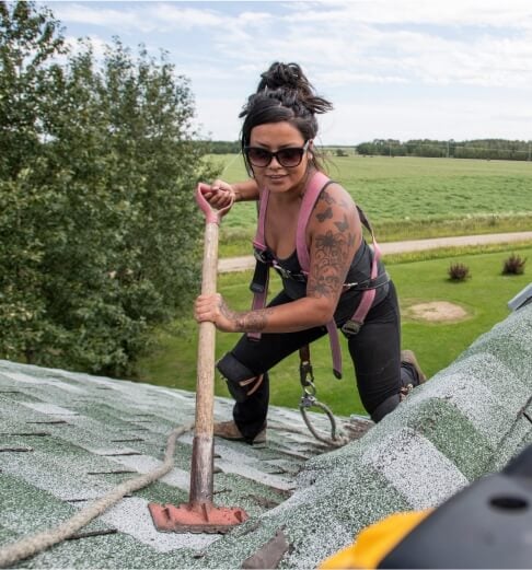 Homes Roofing: professional roofer on house