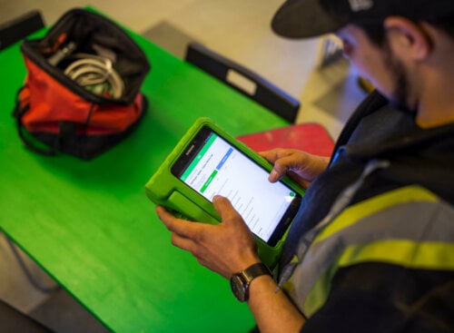 image of plumber working on a tablet
