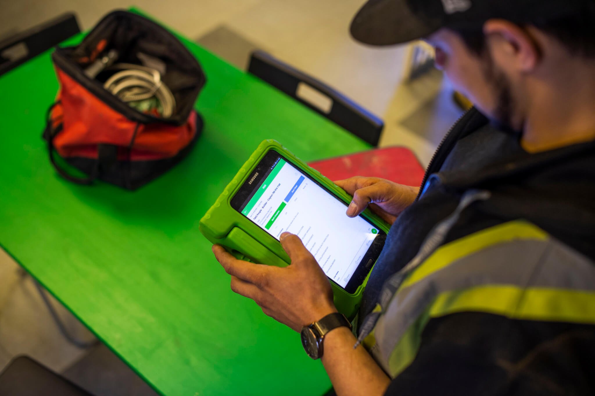 image of plumber working on a tablet
