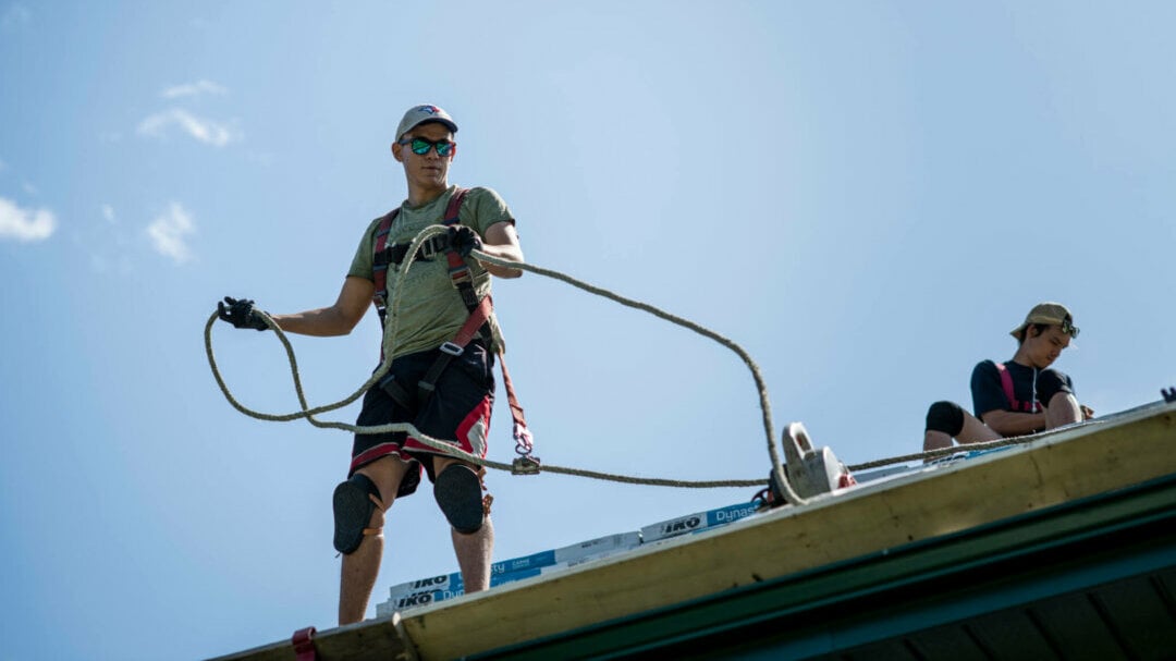 Professional roofer pricing a job