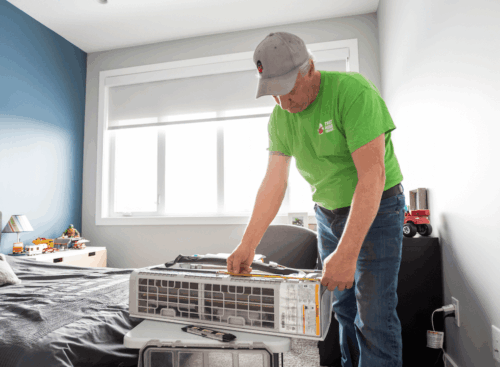 image of an HVAC contractor repairing a home air conditioning unit