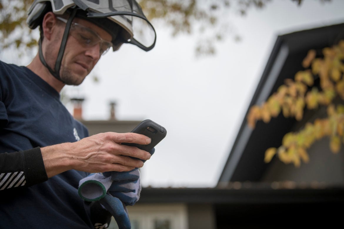 image of arborist on cell phone