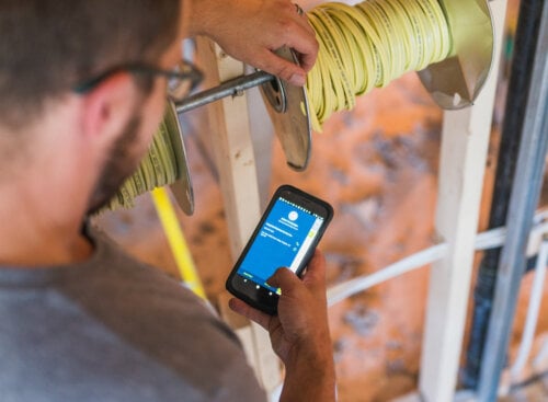 image of electrician working on mobile device