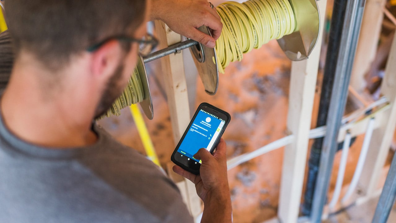 image of electrician working on mobile device