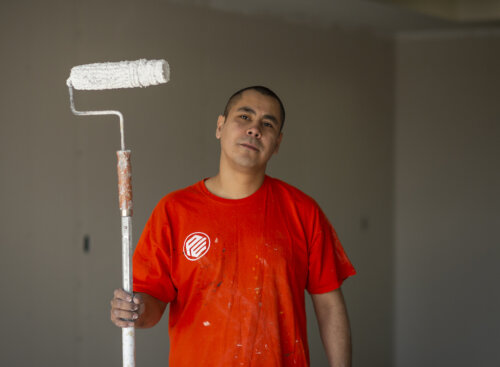 Photo of a painting contractor from Painters Enterprise holding a paint roller