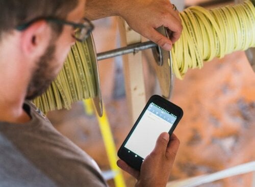 image of electrician on mobile device