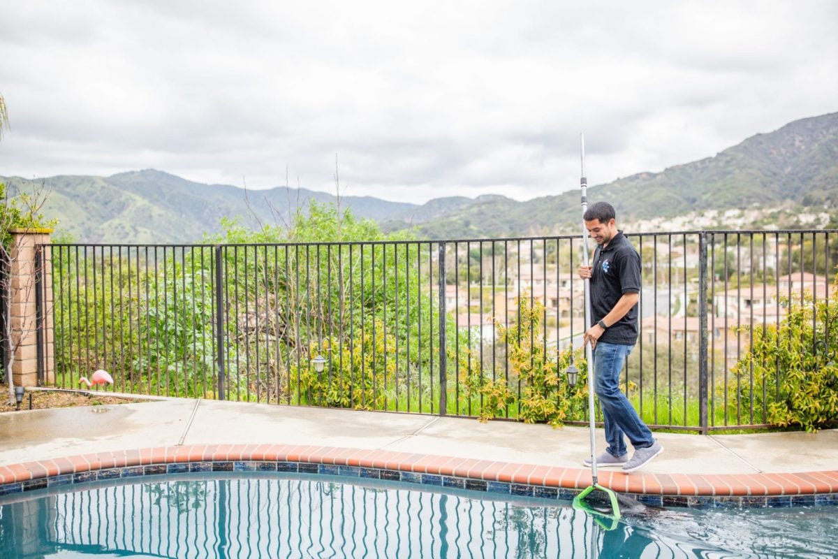 image of service provider cleaning a pool