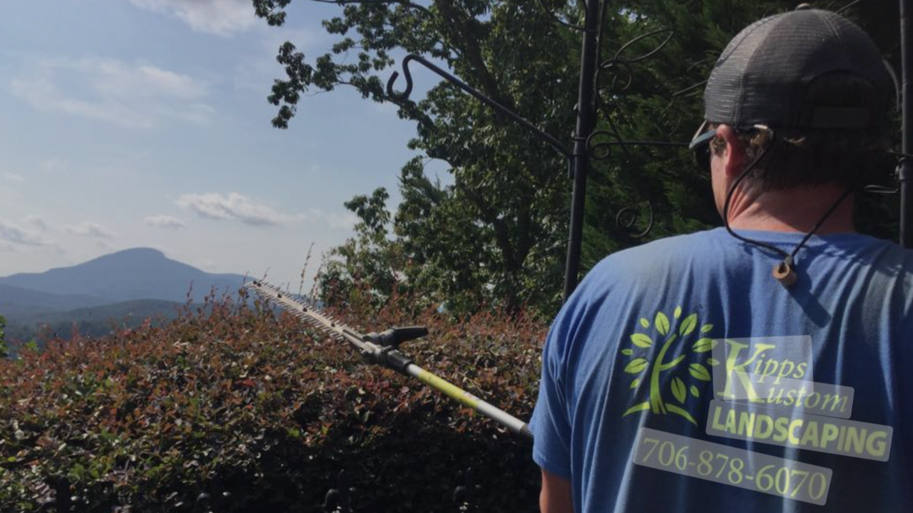 Hunter Kipps of Kipps Custom Landscaping measuring a client's property for a landscaping job