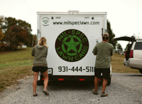 Brian and Kristy Boase of MIL-SPEC Landscaping opening their van outside a customer property to start a landscaping job