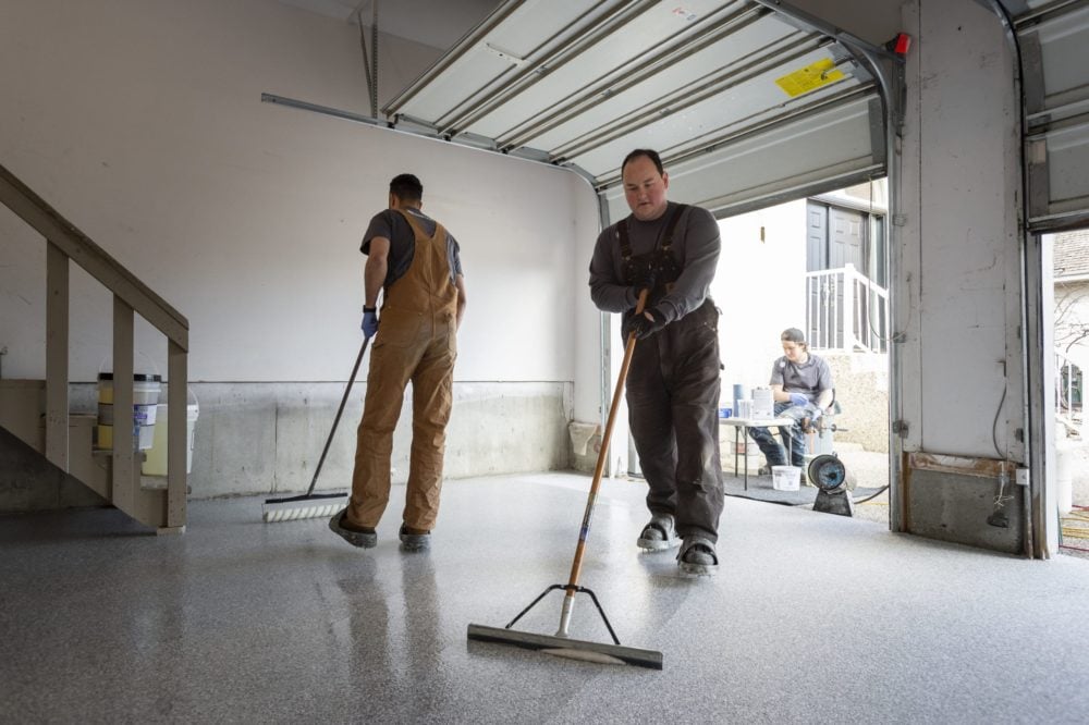 image of two service providers painting a floor