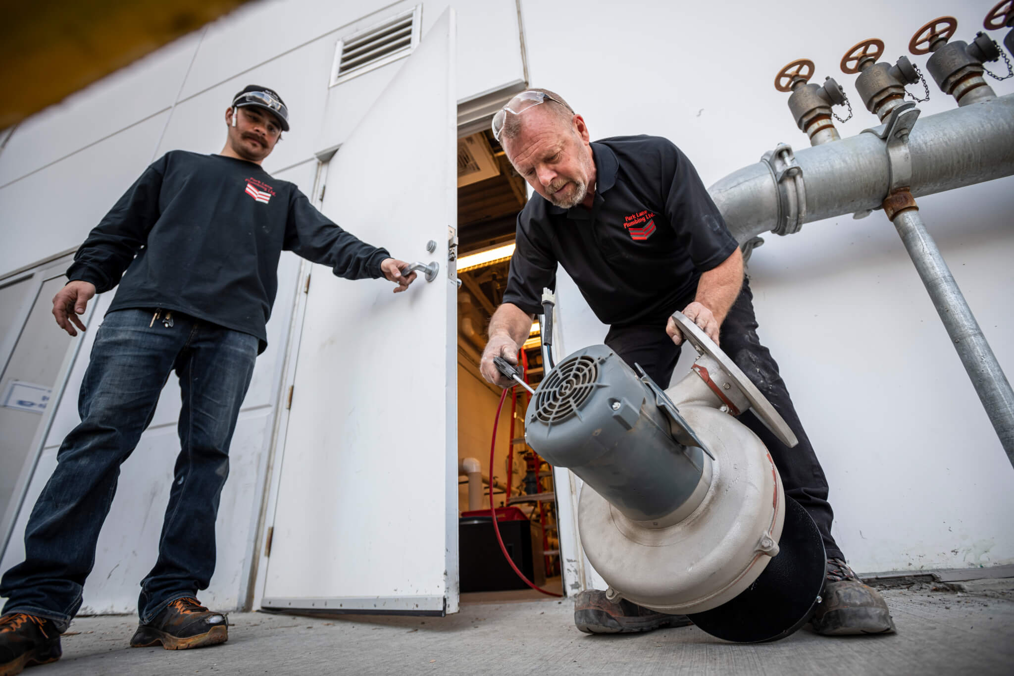 Image of two plumbers working
