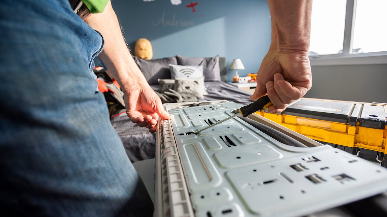 Photo of an HVAC technician repairing an air conditioning unit