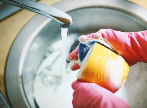 Cleaning Ladies - person washing mug in sink
