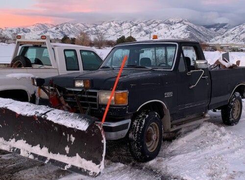 image of two snow plow trucks