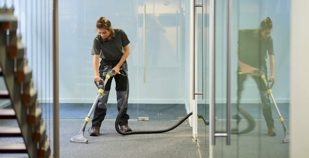 professional carpet cleaner vacuuming an office carpet