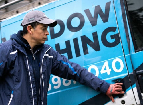 man opening a commercial vehicle door