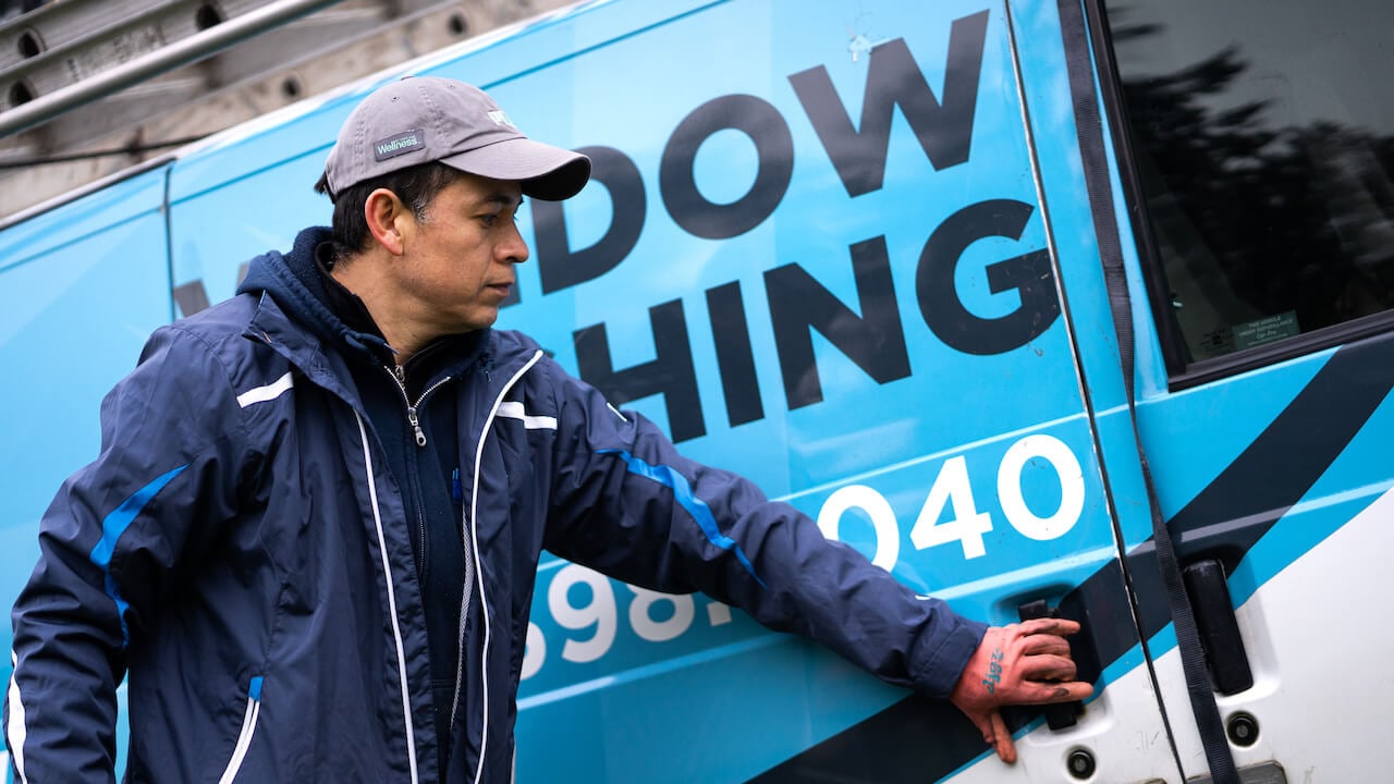 man opening a commercial vehicle door