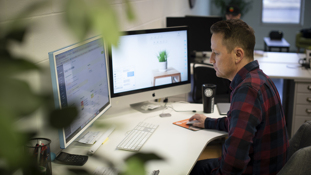 man sitting at computer creating a service business website