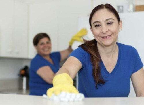 how to start a commercial cleaning business: women cleaning office kitchen