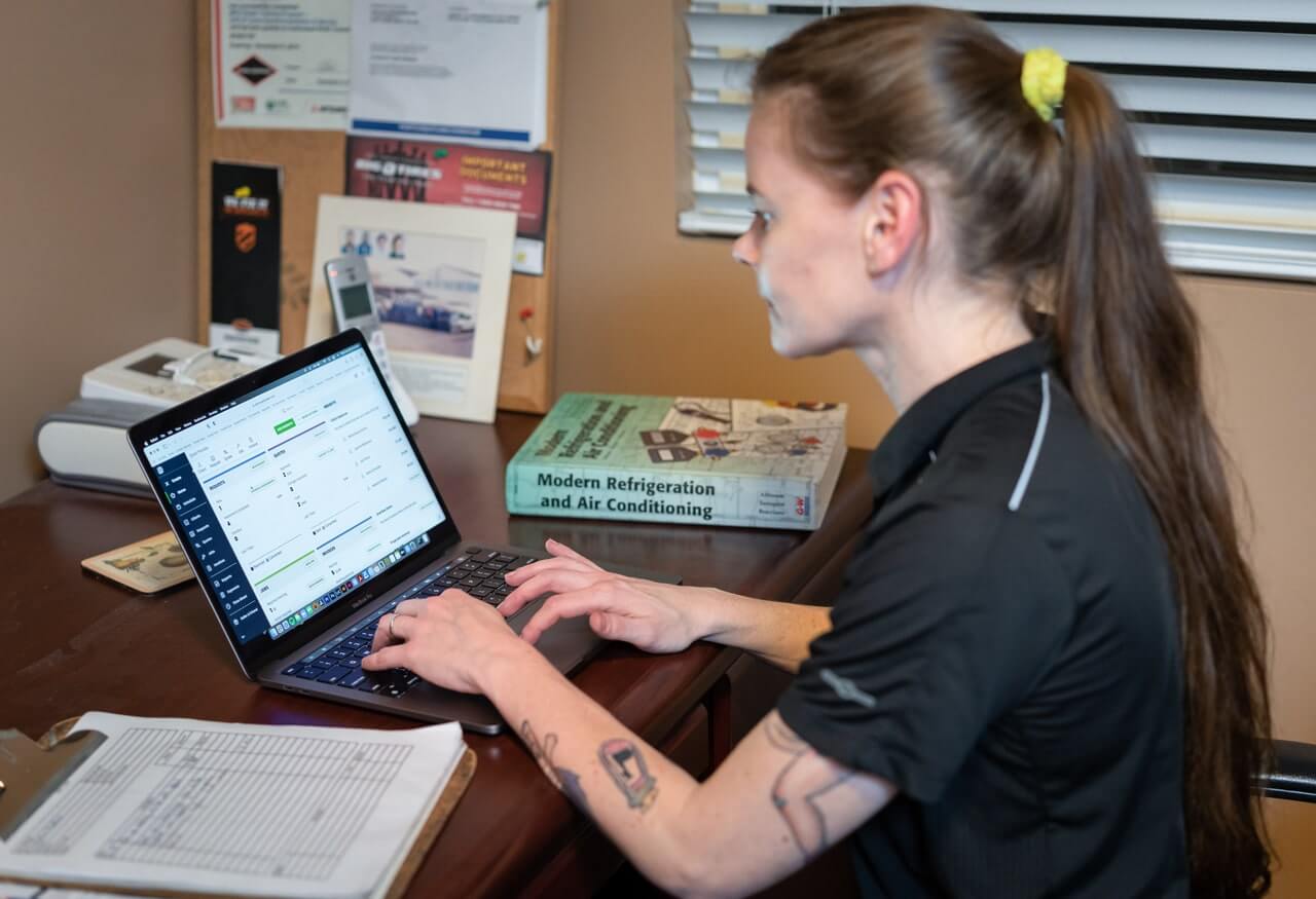 person invoicing at desk