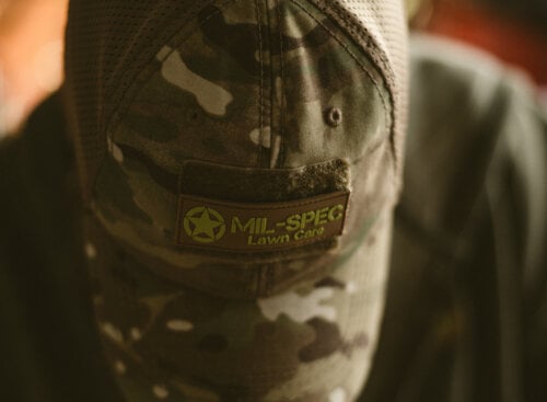 top-down view of a man wearing a branded lawn care hat