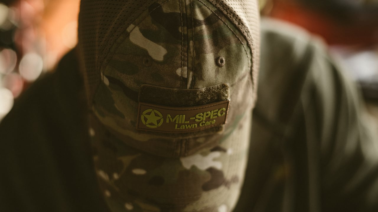 top-down view of a man wearing a branded lawn care hat