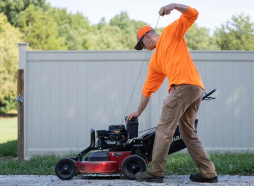 lawn care professional starting a lawnmower