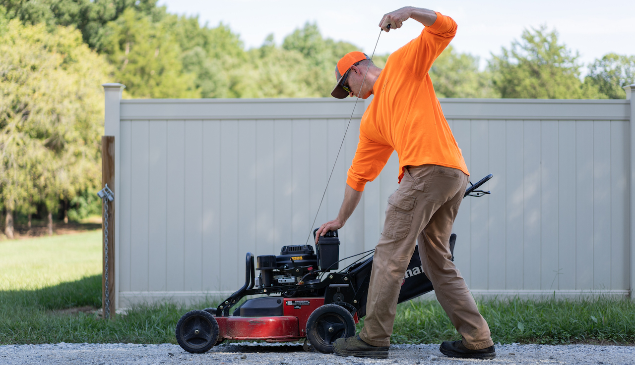 lawn care professional starting a lawnmower